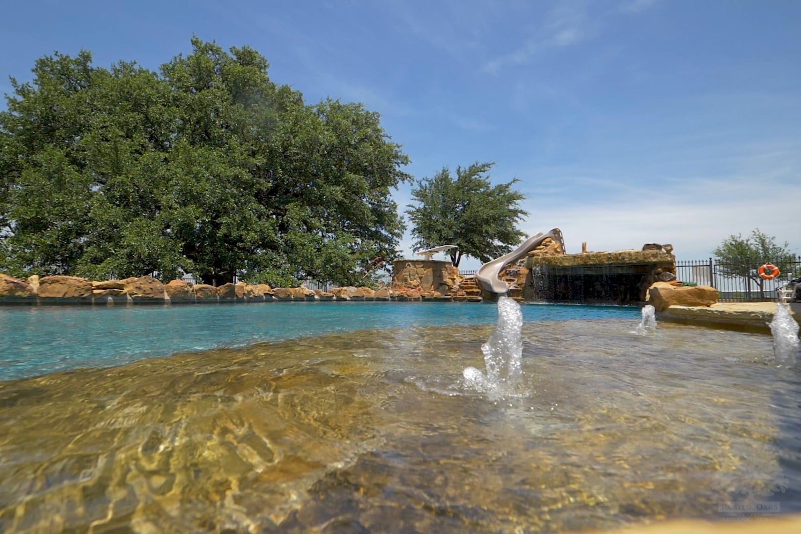 Resort pool with waterslide and diving board — Rusted Oaks Estate